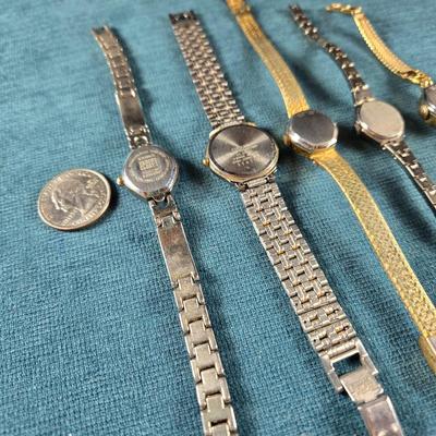 Sale Photo Thumbnail #191: This auction lot is for a Quint of Vintage Ladies Watches. This is a fun grouping of 5 ladies watches.  All need batteries.  From left to right the watch brands are:  Faded Glory (blue face), Seico, Gruen, Benrus (diamond quartz), and lastly, a Benrus (17