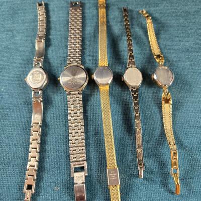 Sale Photo Thumbnail #187: This auction lot is for a Quint of Vintage Ladies Watches. This is a fun grouping of 5 ladies watches.  All need batteries.  From left to right the watch brands are:  Faded Glory (blue face), Seico, Gruen, Benrus (diamond quartz), and lastly, a Benrus (17