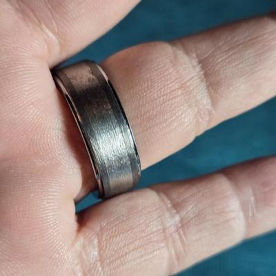 Sale Photo Thumbnail #210: This auction lot is for a Man's Tungsten Carbide Wedding Ring. This man's wedding ring is made of Tungsten Carbide Steel and embedded with 11 lab-grown diamonds.  It is not only very handsome - it is virtually indestructible.  These rings are designed for
