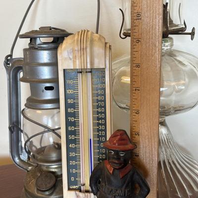 LOT 89: Cast Iron "Give Me a Penny" Bank, Vintage Hurricane/Oil Lamp, Indoor/Outdoor Thermometer & More