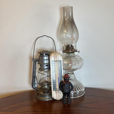 LOT 89: Cast Iron "Give Me a Penny" Bank, Vintage Hurricane/Oil Lamp, Indoor/Outdoor Thermometer & More