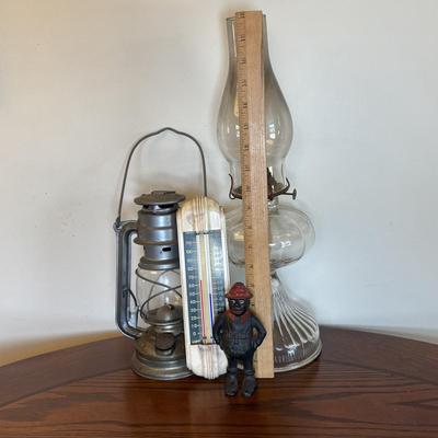 LOT 89: Cast Iron "Give Me a Penny" Bank, Vintage Hurricane/Oil Lamp, Indoor/Outdoor Thermometer & More