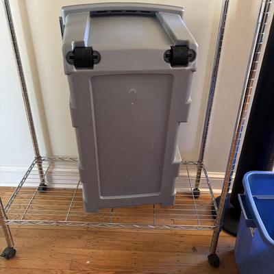 LOT 101: Metal Garment Rack on Wheels, Rubber Maid Storage Tote, Sterilite Footlocker on Wheels & Intertek Tower Fan