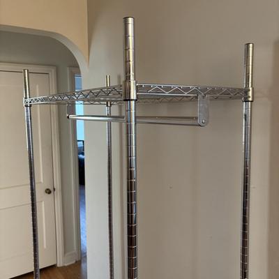 LOT 101: Metal Garment Rack on Wheels, Rubber Maid Storage Tote, Sterilite Footlocker on Wheels & Intertek Tower Fan