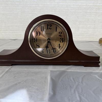 Sale Photo Thumbnail #6: The clock has a faux wood finish and a gold-colored face with black numbers