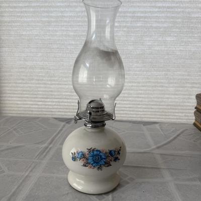 Sale Photo Thumbnail #10: The lamp features a cream-colored or ivory cased glass base with a floral design of blue and pink flowers