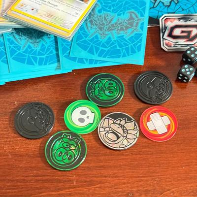 LOT 259D: Sleeved Pokémon Deck, Empty Collectors Tins & More