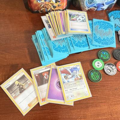 LOT 259D: Sleeved Pokémon Deck, Empty Collectors Tins & More