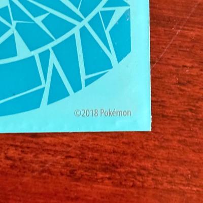 LOT 259D: Sleeved Pokémon Deck, Empty Collectors Tins & More