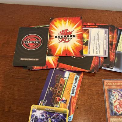 LOT 264: 1996 Yugioh Cards, Heavily Played Pokémon Cards & More