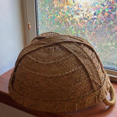 A large, vintage woven river reed basket with braided handles 20”w x14”d x 10”h