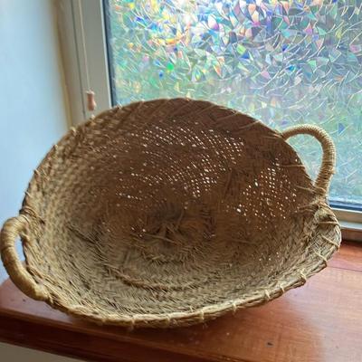 A large, vintage woven river reed basket with braided handles 20”w x14”d x 10”h