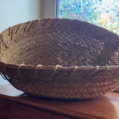 A large, vintage woven river reed basket with braided handles 20”w x14”d x 10”h