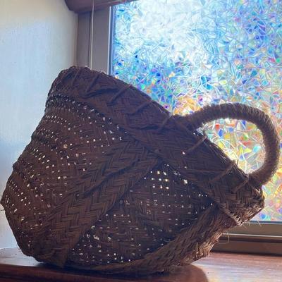 A large, vintage woven river reed basket with braided handles 20”w x14”d x 10”h