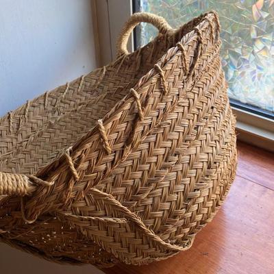 A large, vintage woven river reed basket with braided handles 20”w x14”d x 10”h