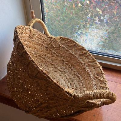 A large, vintage woven river reed basket with braided handles 20”w x14”d x 10”h