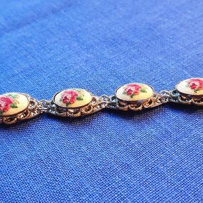 Sale Photo Thumbnail #431: Beautiful cross stitch segment with silvertone filigree backing.  
very good condition