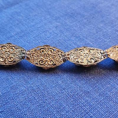 Sale Photo Thumbnail #432: Beautiful cross stitch segment with silvertone filigree backing.  
very good condition