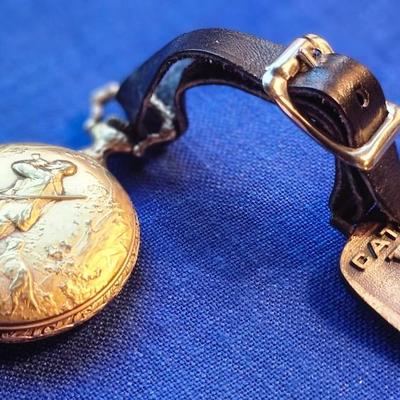 Sale Photo Thumbnail #434: with CAT Engines pocket fob
Tenco   Sacramento
The watch case has heavy repousse hunting scene on one side
The watch is not working.  17 jewel Incabloc movement
12 and 24 hour marks, Swiss made
This is a great collectible.