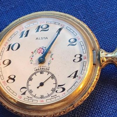 Sale Photo Thumbnail #435: with CAT Engines pocket fob
Tenco   Sacramento
The watch case has heavy repousse hunting scene on one side
The watch is not working.  17 jewel Incabloc movement
12 and 24 hour marks, Swiss made
This is a great collectible.