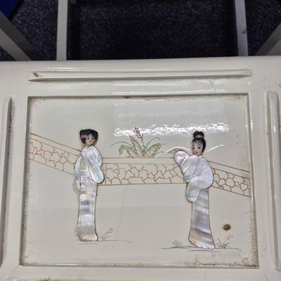 Sale Photo Thumbnail #472: Lovely set of 3 stacking tables in white lacquer 
There are a few small chips in the lacquer
Images in excellent condition 
large is 20 x 14 x 26 inches tall
medium is 13 x 10 x 18 inches tall
small is 9 x 9 x 14 inches tall