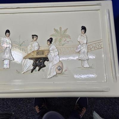 Sale Photo Thumbnail #471: Lovely set of 3 stacking tables in white lacquer 
There are a few small chips in the lacquer
Images in excellent condition 
large is 20 x 14 x 26 inches tall
medium is 13 x 10 x 18 inches tall
small is 9 x 9 x 14 inches tall