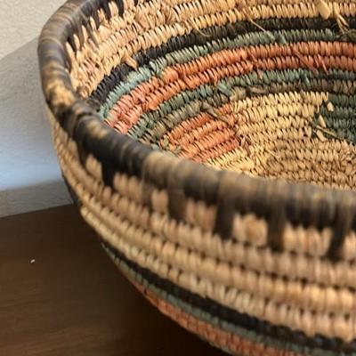 Vintage African coiled basket with multicolor geometric patterns. 9.5” across x 5.5”h