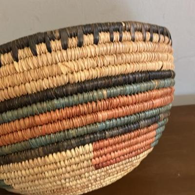 Vintage African coiled basket with multicolor geometric patterns. 9.5” across x 5.5”h