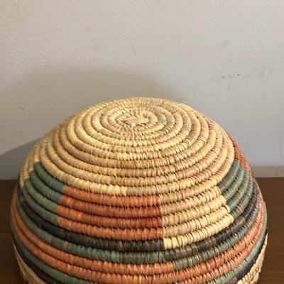 Vintage African coiled basket with multicolor geometric patterns. 9.5” across x 5.5”h