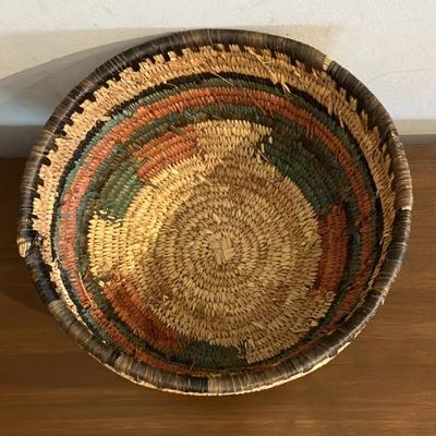 Vintage African coiled basket with multicolor geometric patterns. 9.5” across x 5.5”h