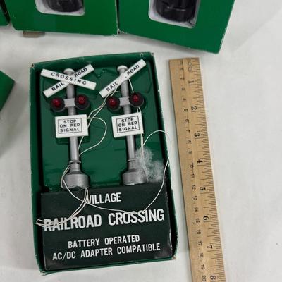 Sale Photo Thumbnail #153: Battery powered railroad crossing signs. Can also be converted to DC (plug-in) power. Look to be for 027 gauge. Near new condition with original boxes. Made in Taiwan.