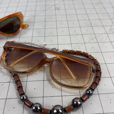 2 pair of Sunglasses and a Necklace