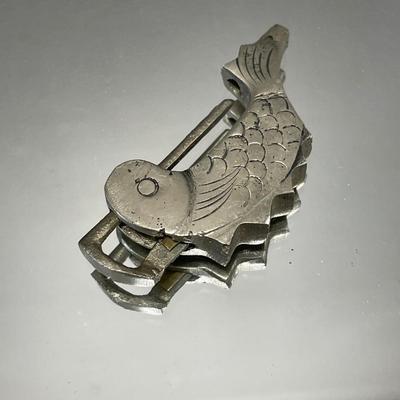 Fish padlock and dancing broom brooch