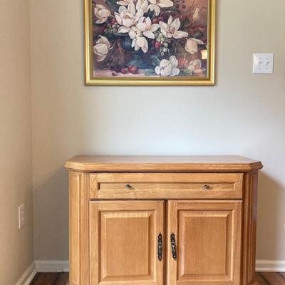 LOT 75: Wooden Storage Cabinet with Framed Magnolia Floral Artwork by Barbara Mock