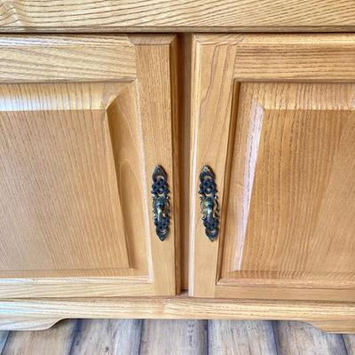 LOT 75: Wooden Storage Cabinet with Framed Magnolia Floral Artwork by Barbara Mock