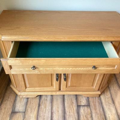 LOT 75: Wooden Storage Cabinet with Framed Magnolia Floral Artwork by Barbara Mock