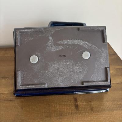 LOT 104: Large Blue Wicker Basket w/Ceramic Handles, LBK Berry Design Pitcher, Blue/White Candlesticks, Metal Flower Vase, Blue Glaze...