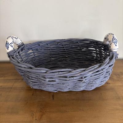 LOT 104: Large Blue Wicker Basket w/Ceramic Handles, LBK Berry Design Pitcher, Blue/White Candlesticks, Metal Flower Vase, Blue Glaze...