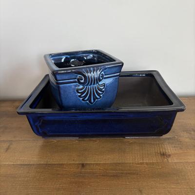 LOT 104: Large Blue Wicker Basket w/Ceramic Handles, LBK Berry Design Pitcher, Blue/White Candlesticks, Metal Flower Vase, Blue Glaze...