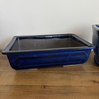 LOT 104: Large Blue Wicker Basket w/Ceramic Handles, LBK Berry Design Pitcher, Blue/White Candlesticks, Metal Flower Vase, Blue Glaze...