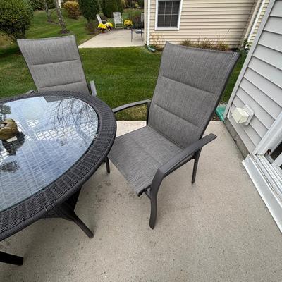 LOT 105: Stylewell Outdoor Patio Chairs along with a Round Wicker & Glass Patio Table