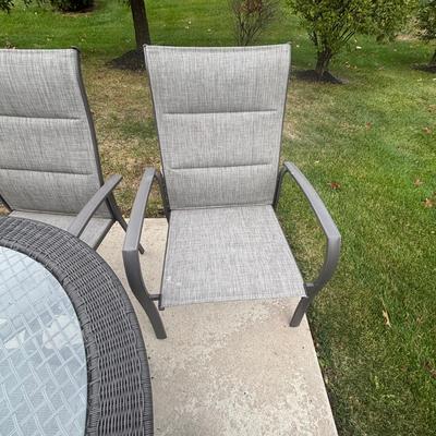 LOT 105: Stylewell Outdoor Patio Chairs along with a Round Wicker & Glass Patio Table