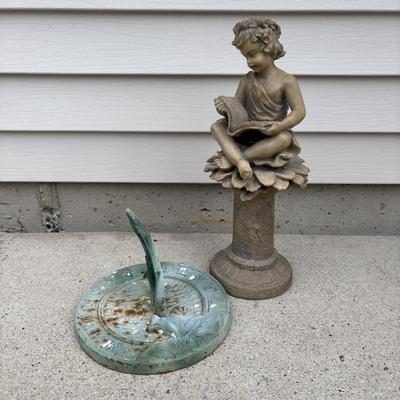 LOT 107: Cast Iron Sundial and Resin Cherub Reading a Book Garden Statue