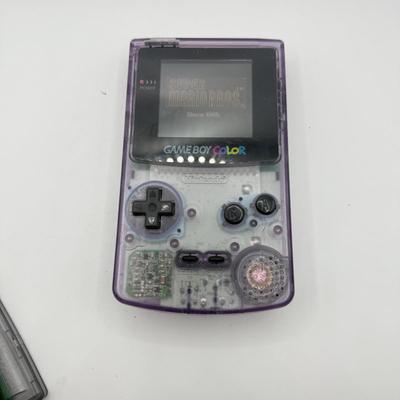 LOT 166F: Nintendo GameBoy Color Transparent Purple Model CGB-0010 (Works, Missing battery cover), Super Mario Bros Deluxe & 101...