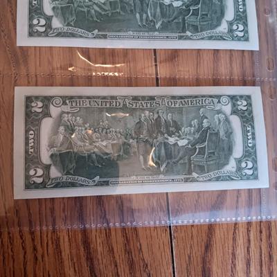 SIX 2 DOLLAR BILLS 2 FROM LEFT SIDE AND 2 FROM RIGHT ARE SEQUENCIAL