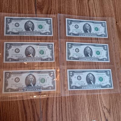 SIX 2 DOLLAR BILLS 2 FROM LEFT SIDE AND 2 FROM RIGHT ARE SEQUENCIAL