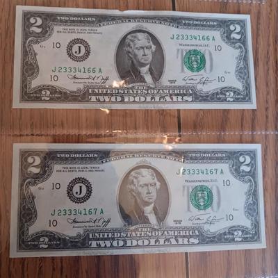 SIX 2 DOLLAR BILLS 2 FROM LEFT SIDE AND 2 FROM RIGHT ARE SEQUENCIAL