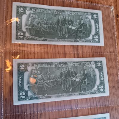 SIX 2 DOLLAR BILLS 2 FROM LEFT SIDE AND 2 FROM RIGHT ARE SEQUENCIAL