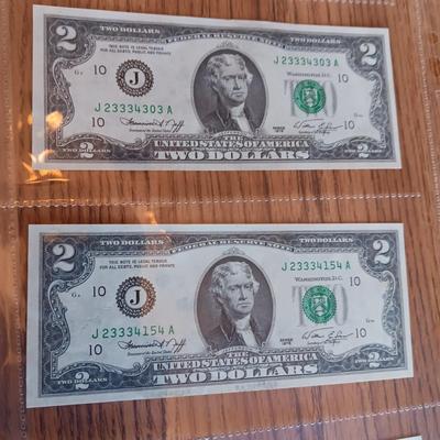 SIX 2 DOLLAR BILLS 2 FROM LEFT SIDE AND 2 FROM RIGHT ARE SEQUENCIAL