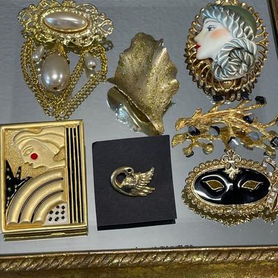 Gold tone brooches